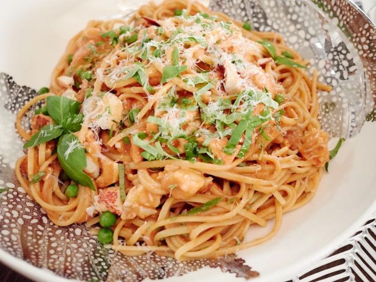 a white plate topped with pasta covered in sauce