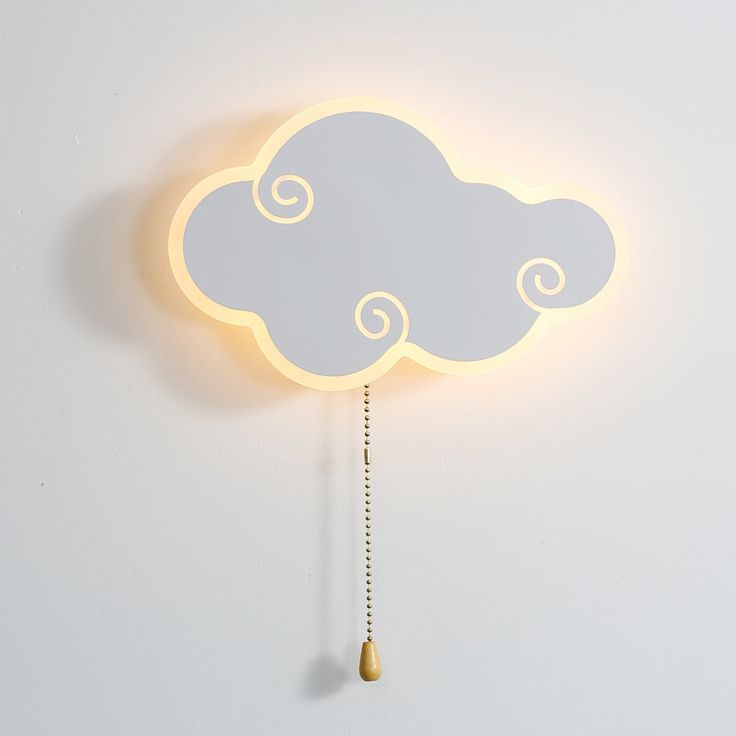 a clock with a cloud shaped light hanging from it's side on a wall