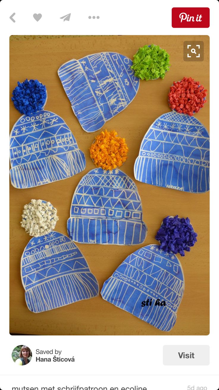 four hats made out of paper with flowers on them, all in blue and white