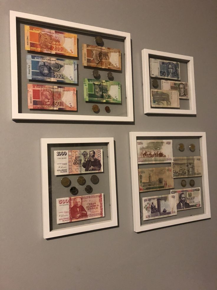 three framed currency pieces on the wall