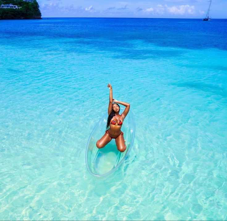 a woman is floating in the clear blue water