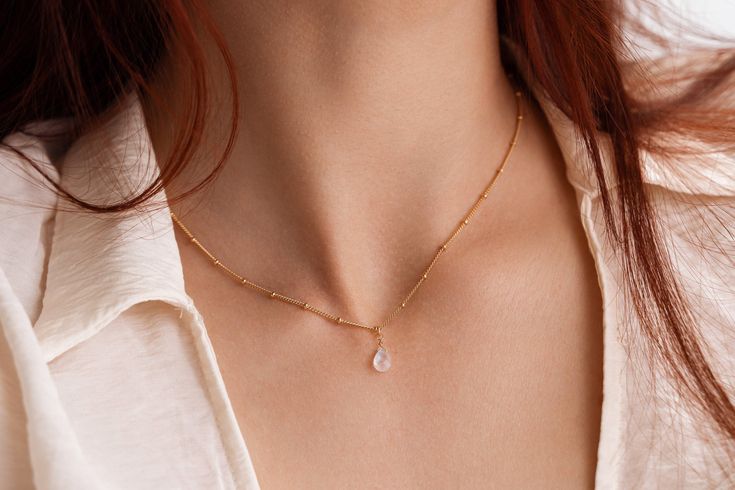 "HELENE," bead chain dainty teardrop moonstone necklace. All components are made with genuine, 14K GOLD FILLED (not plated) brass, hand assembled. We offer chains of two length for this necklace: a choker length of approximately 40CM/~16 Inches and 45cm/~18 inches.  The pendant is is made with a genuine natural CLEAR quality, blue flash, faceted moonstone.  They're great for wearing alone or stacking with a nice pendant! They're super easy to incorporate into to your everyday wardrobe, as a uniq Dainty Moonstone Teardrop Pendant Necklace, Dainty Wire Wrapped Teardrop Necklace, Dainty Teardrop Wire Wrapped Necklace, Delicate Teardrop Moonstone Necklace, Elegant Teardrop Jewelry With Tiny Beads, Dainty Handmade Teardrop Crystal Necklace, Dainty Handmade Drop Necklace, Dainty Crystal Necklace With Teardrop Pendant On Delicate Chain, Dainty Teardrop Pendant Drop Necklace