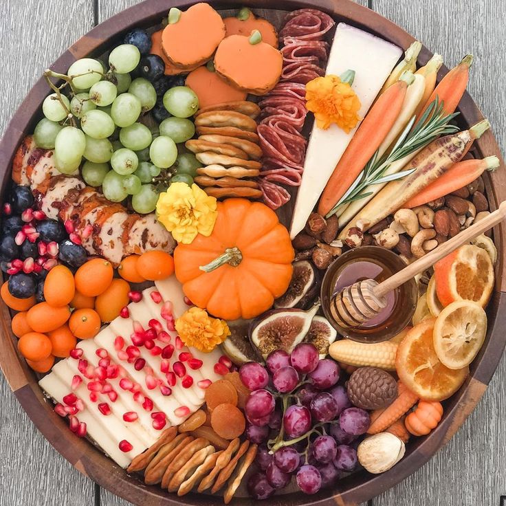 a wooden platter filled with lots of different types of food