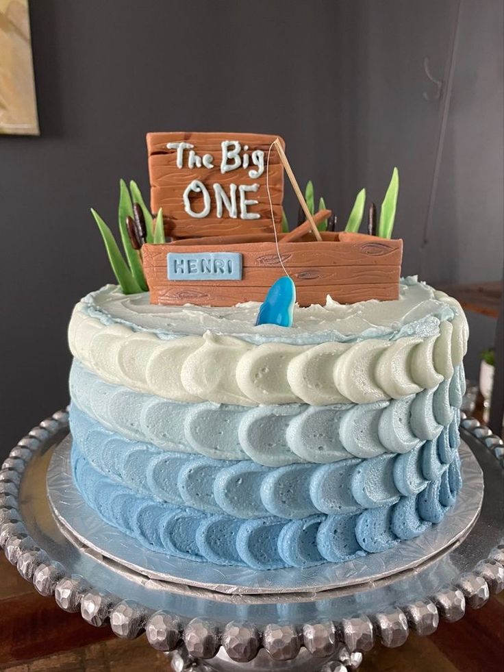 there is a blue and white cake that has the words the big one on it