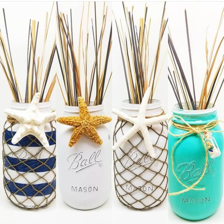 three mason jars with straws and starfish decorations