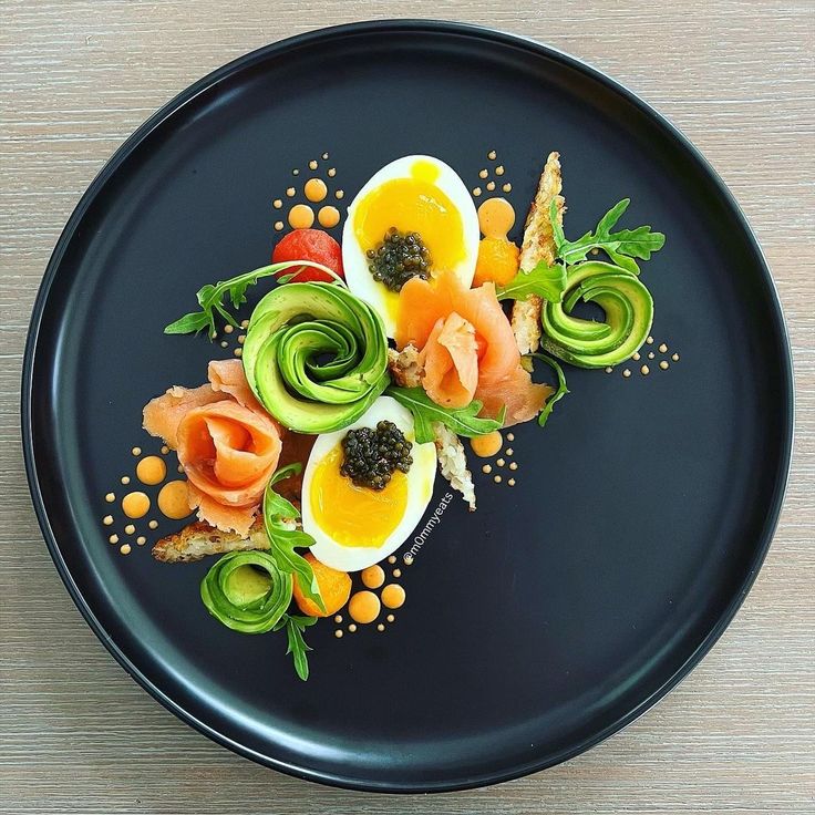 a black plate topped with different types of food