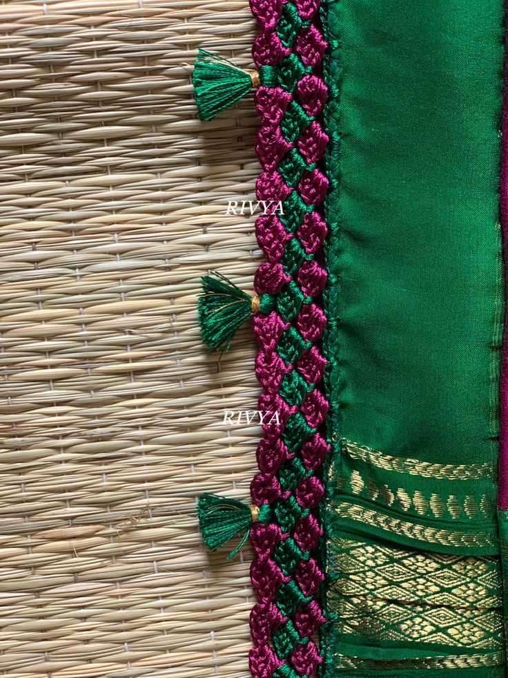 green and pink fabric with tassels on woven wicker wall hanging or basket