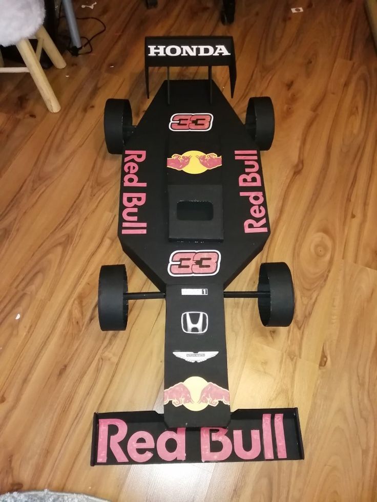 a race car made out of cardboard on the floor