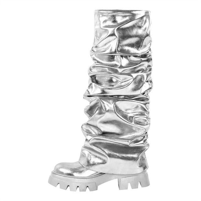 a pair of silver boots with stacked heels on the bottom and side, all in metallic