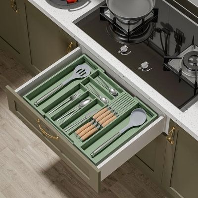 an open drawer with utensils in it