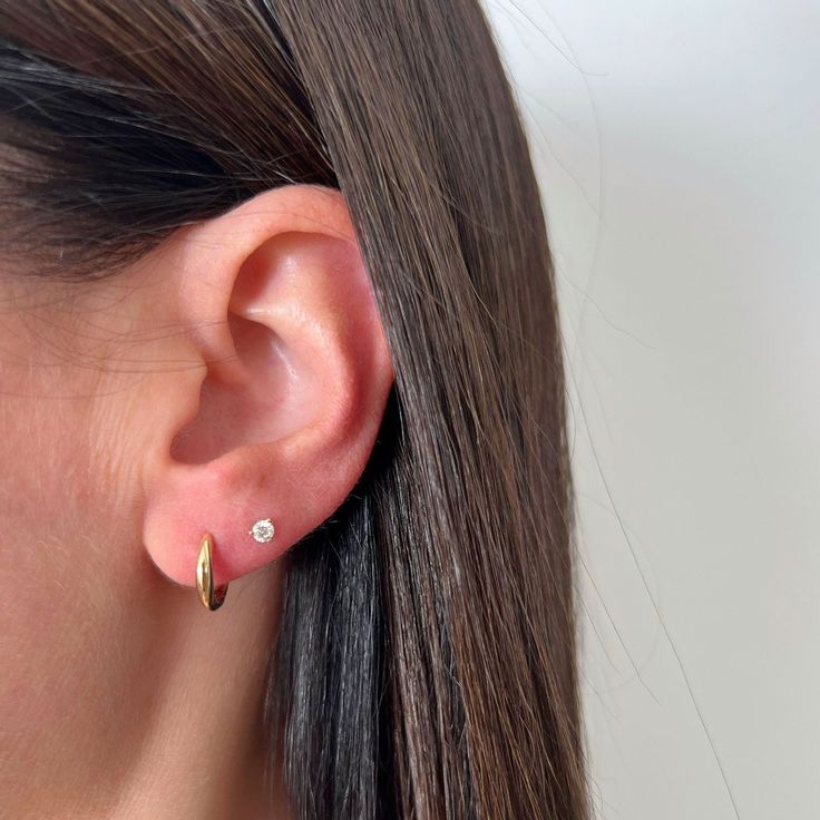 The Gold Dome Huggie Earring is a unique spin on a traditional huggie, thanks to its dome-like silhouette. Crafted from 14k gold, this huggie is perfect for everyday wear and looks just as good in the lobe as it does higher up the ear. Round Ear Free Lobe Piercings, Classic Tarnish-resistant Huggie Cartilage Earrings, Classic Huggie Everyday Piercings, Classic Huggie Piercings For Everyday, 14k White Gold Huggie Cartilage Earrings, Pierced White Gold Huggie Earrings, White Gold Pierced Huggie Earrings, Timeless Diamond Huggie Earrings For Everyday, Hypoallergenic Huggie Diamond Earrings