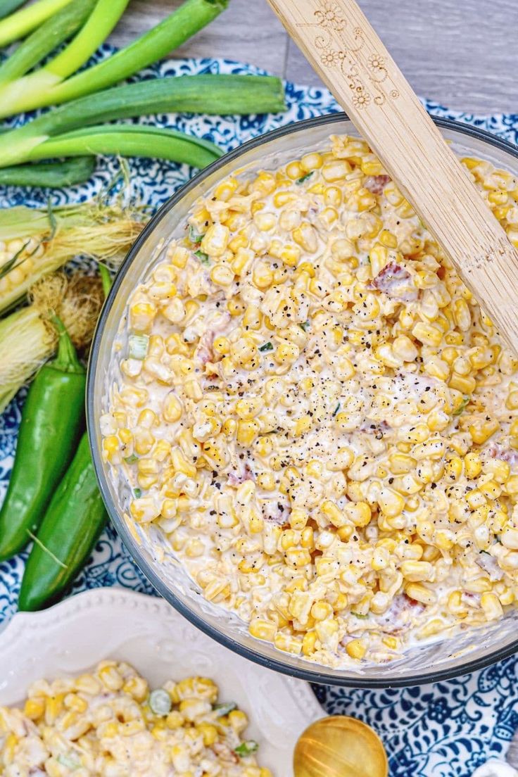 a bowl filled with corn next to green beans