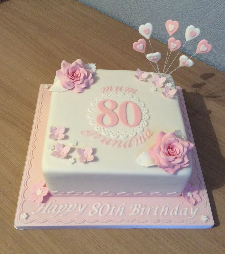 a birthday cake with pink flowers and hearts on the top is for an 80th birthday