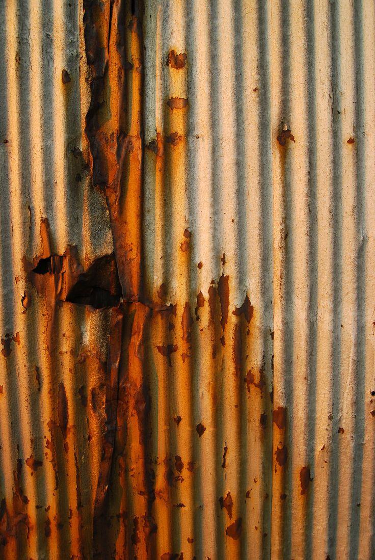 rusted metal surface with peeling paint on it