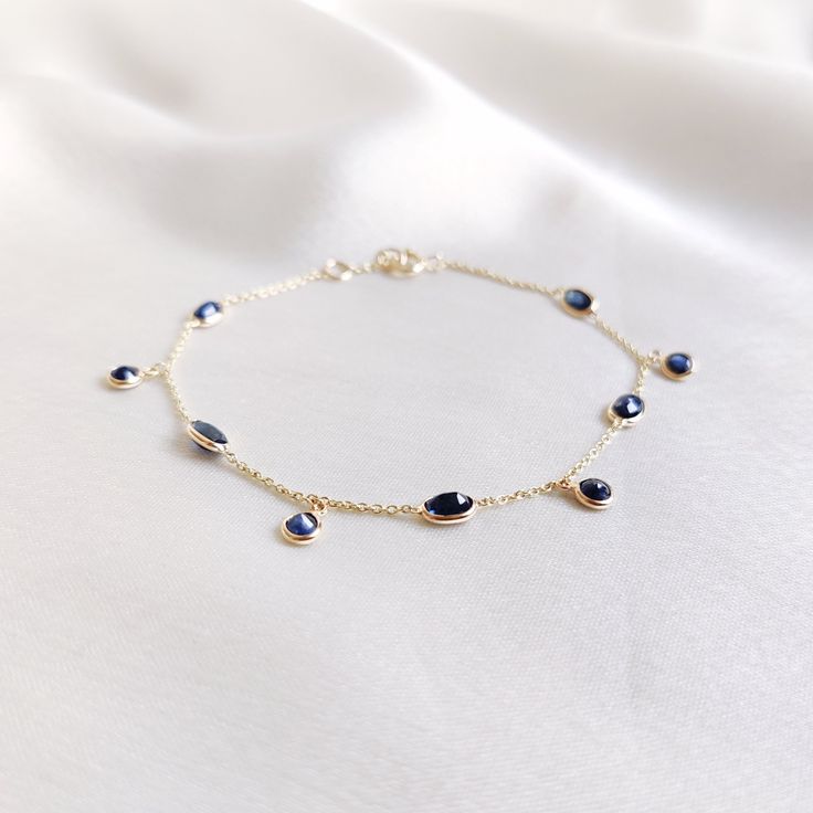 This stunning bracelet is set in 14k Solid Yellow Gold with Natural Blue Sapphire. It is an unique and dainty gemstone  bracelet for nearly every occasion and is completely hassle-free jewelry. ITEM DETAILS: * Gem: Blue Sapphire * Gem Size: 3mm (4pcs) * Gem Shape: Round cut * Gem Size: 3x5mm (5pcs) * Gem Shape: Oval cut * Gem Weight: 2.81 carats * Gold Purity: 14KT * Gold Weight: 1.14 gram * Total Weight of the Bracelet: 1.70 gram ✔️The Gold purity is guaranteed and it comes with authentic 14KT Yellow Gold Gemstone Bracelets For Party, Yellow Gold Gemstone Bracelet For Party, Party Jewelry With Gemstones In 14k Gold, Party Jewelry In 14k Gold With Gemstones, 14k Gold Gemstone Jewelry For Parties, Party 14k Gold Gemstone Jewelry, Elegant Sapphire Bracelets For Gift, Elegant Sapphire Bracelets As Gift, Elegant Sapphire Bracelets Perfect For Gifts