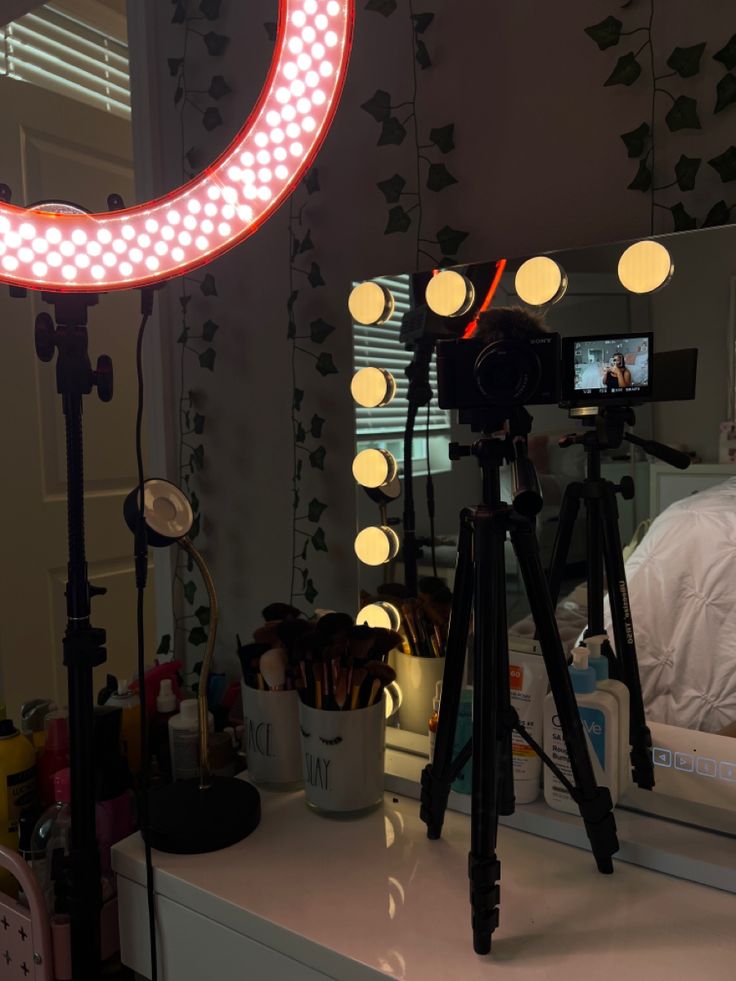 a tripod light sitting on top of a table next to a mirror