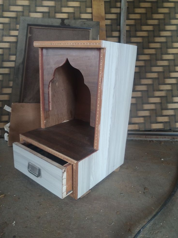 an open wooden cabinet sitting on top of a floor