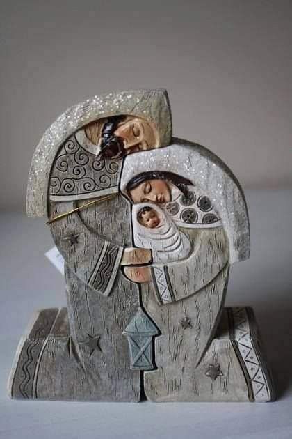 a ceramic sculpture of a man's head with his eyes closed