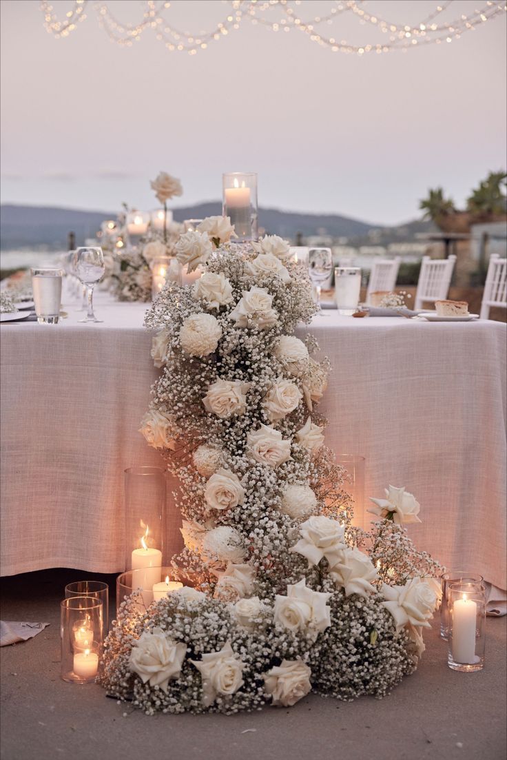 a table with candles and flowers on it