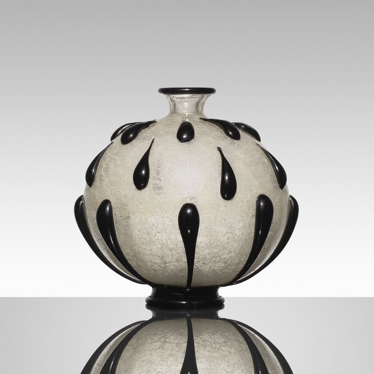 a black and white vase sitting on top of a table