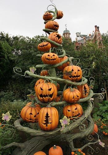 a tree made out of pumpkins in a garden