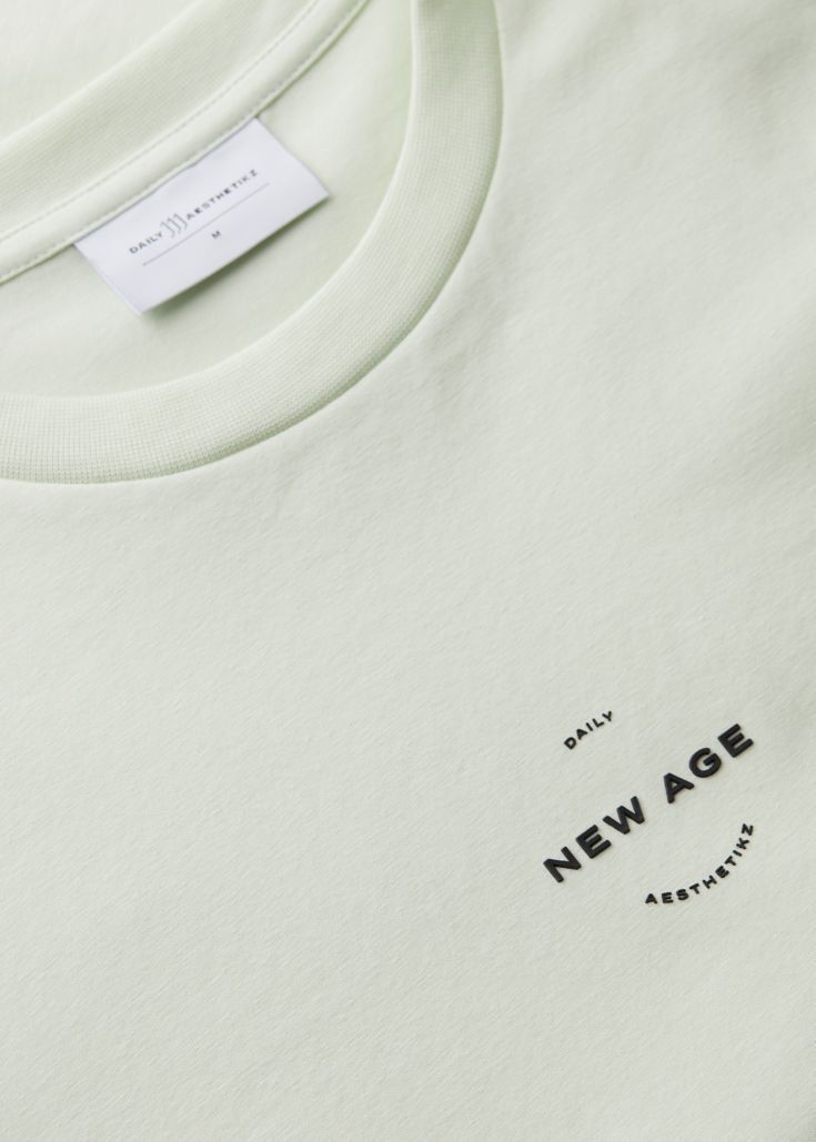 a white t - shirt with the words new age printed on it's chest