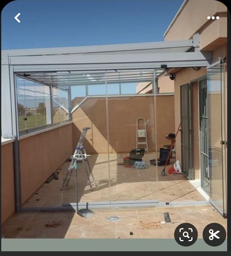 an image of a patio being remodeled with glass walls and sliding doors on the outside