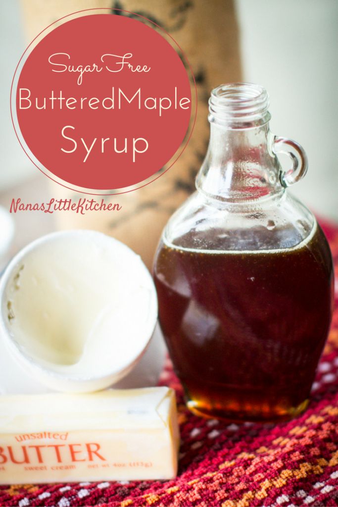 a bottle of buttered maple syrup next to an empty cup and box of butter