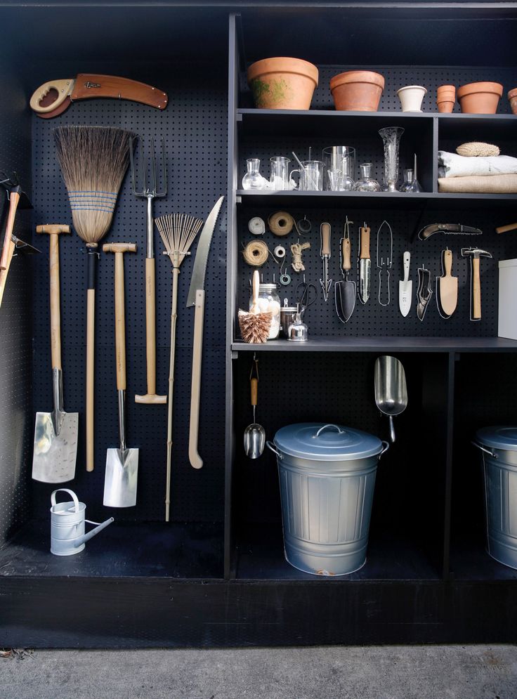 a shelf filled with lots of different types of gardening utensils and other items