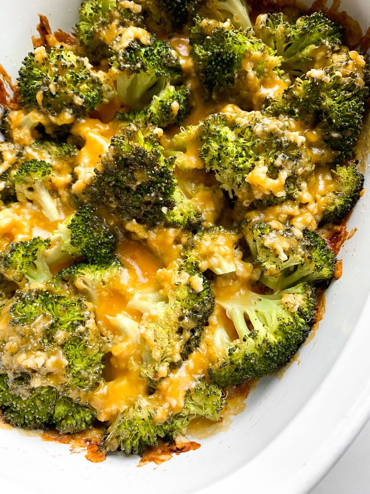 broccoli and cheese casserole in a white bowl on top of a table