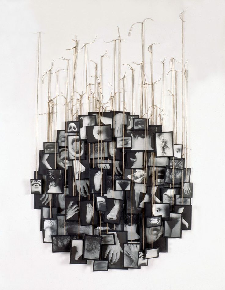 a sculpture made out of multiple pictures hanging from strings