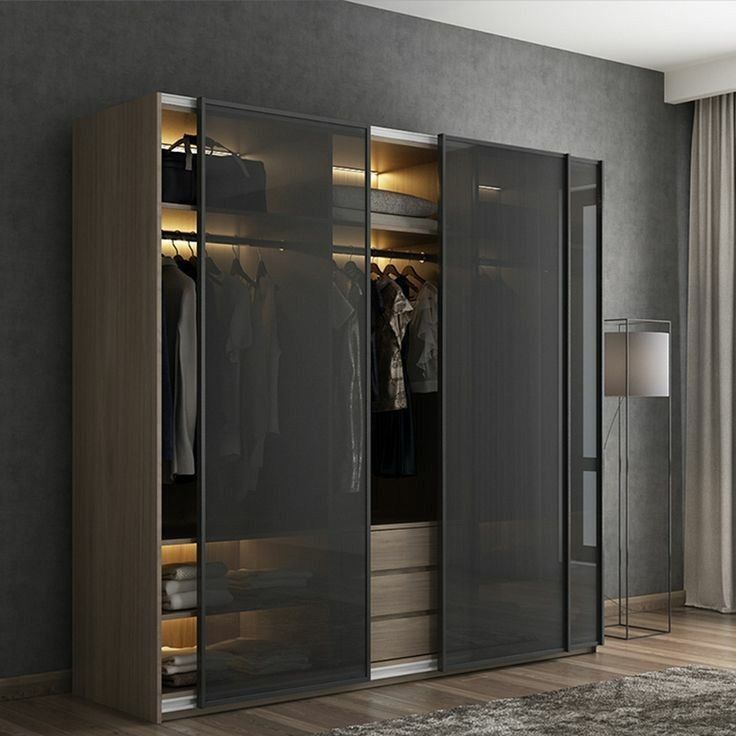 an open closet with clothes hanging in it