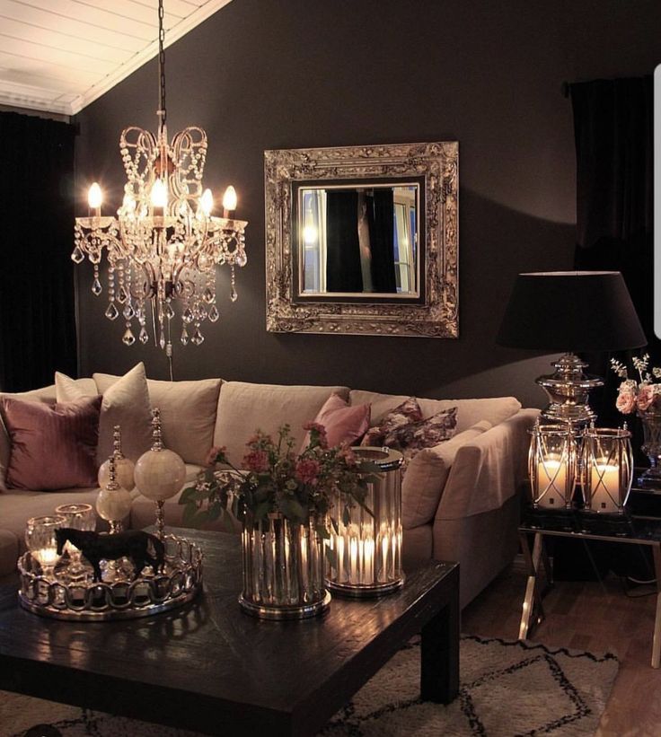 a living room filled with furniture and a chandelier