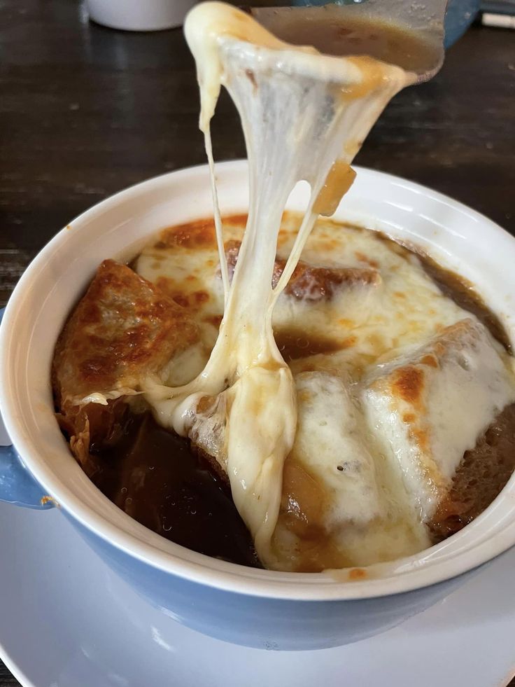 a white bowl filled with food on top of a table