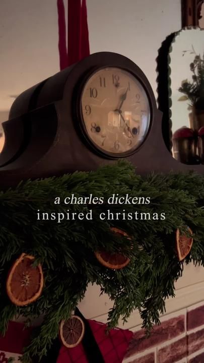 a clock that is sitting on top of a mantle in front of a mirror with the words, a charles dickens inspired christmas