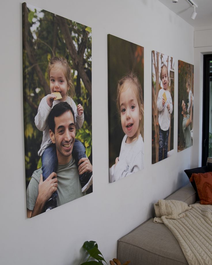 three pictures are hanging on the wall above a bed