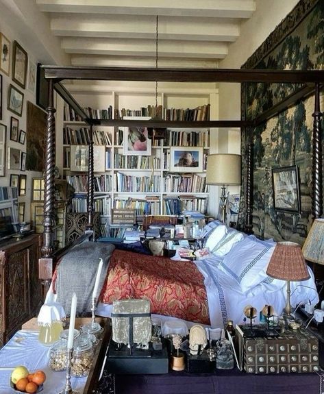 a bed room with a neatly made bed and lots of books