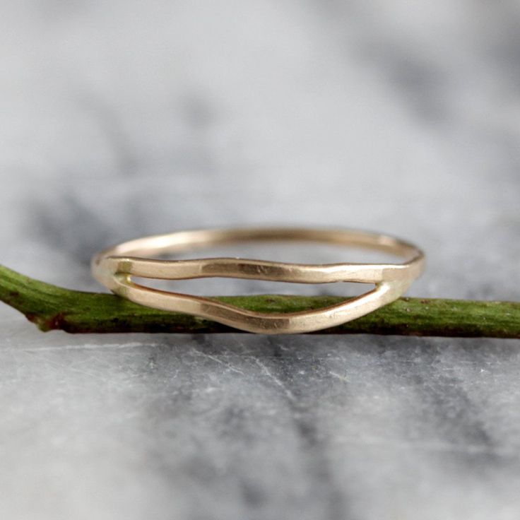 This delicate yet striking ring is made from one piece of hammered metal which wraps one and a half times around your finger, giving the appearance of two wavey stacking rings, yet maintaining the negative space between each band. The ring is wrapped and then soldered closed so it maintains both its shape and size. It has a lovely subtle hammered texture which adds dimension and sparkle. Available in sterling silver and 14k gold fill, as well as solid 14k gold in yellow and rose. sizes 5-9. All Simple Hammered 14k Gold Rings, 14k Gold Hammered Bands, Stackable 14k Gold Bypass Ring With Open Band, Hammered 14k Gold Open Stackable Rings, 14k Gold Stackable Bypass Ring With Open Band, Minimalist 14k Gold Wavy Ring, Minimalist Yellow Gold Wavy Ring, Minimalist Wavy Yellow Gold Ring, Stackable Open Band Rings In Recycled Gold