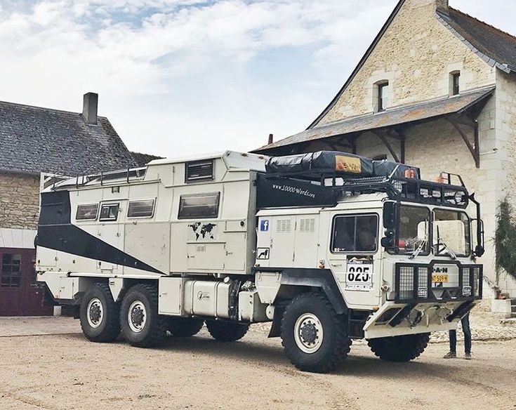 an army truck parked in front of a building