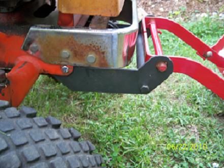 a red lawn mower sitting in the grass