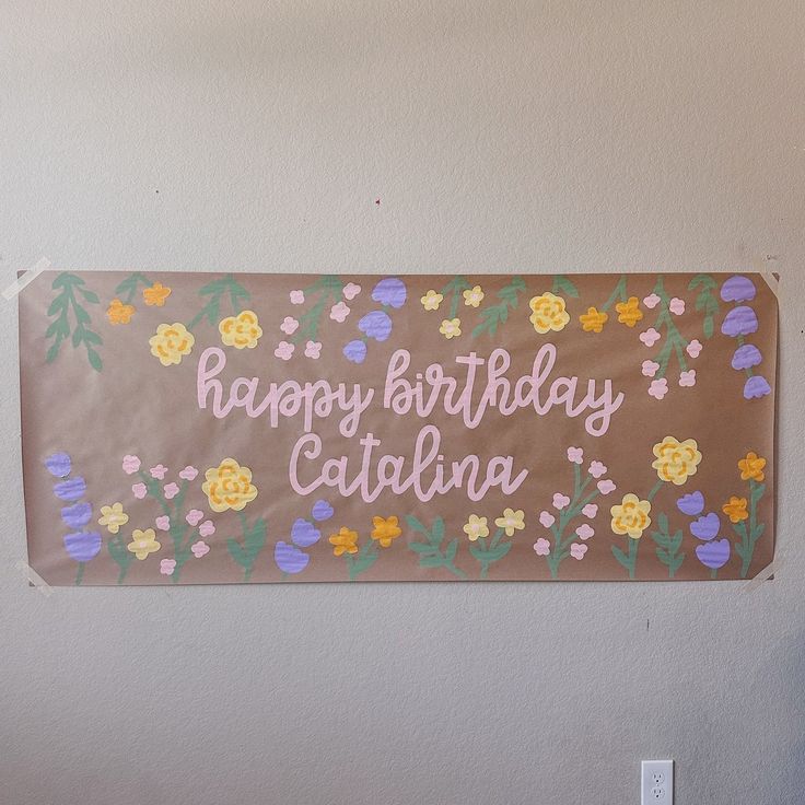 a happy birthday sign hanging on the wall