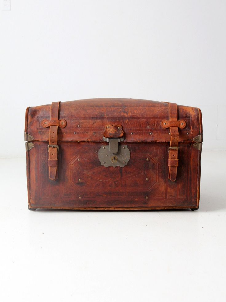 an old wooden suitcase with two straps on it