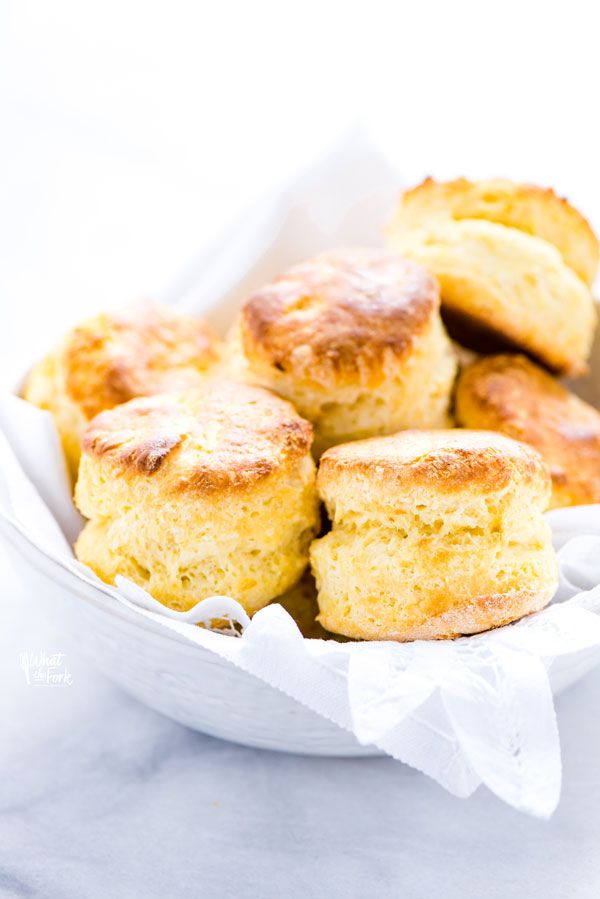 some biscuits in a white bowl with the words gluten free scones