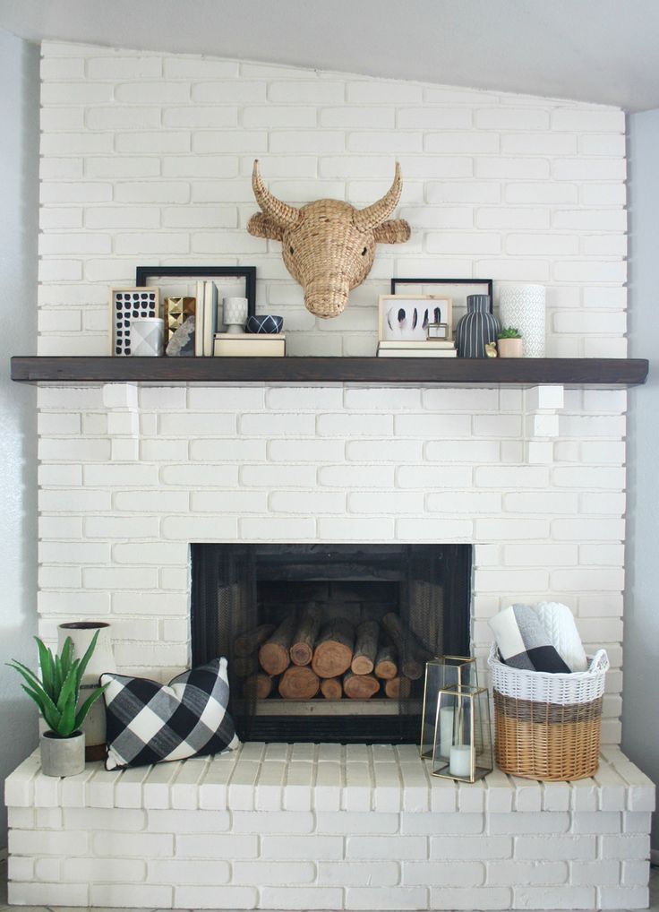 a white brick fireplace with shelves above it and a buffalo head on the mantel