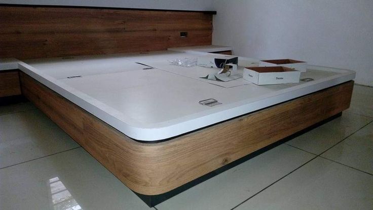 a table with two boxes sitting on top of it next to a white tiled floor