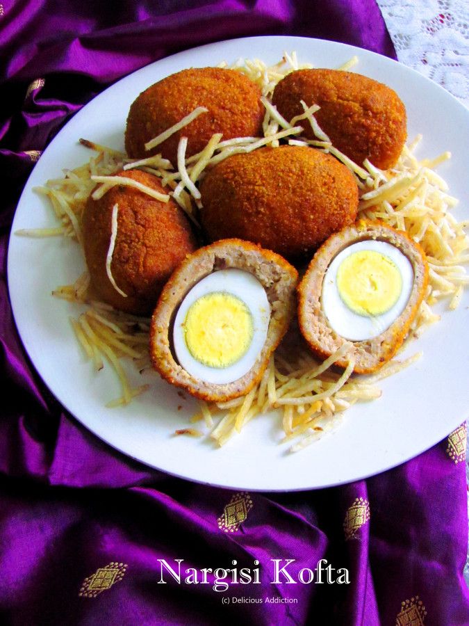 some food is on a white plate with purple cloth