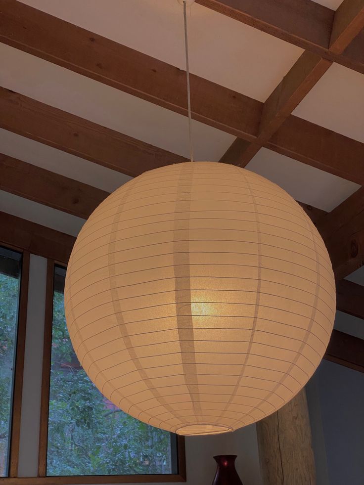 a large white paper lantern hanging from the ceiling