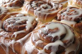 there are many cinnamon rolls with icing on the top and bottom one is glazed