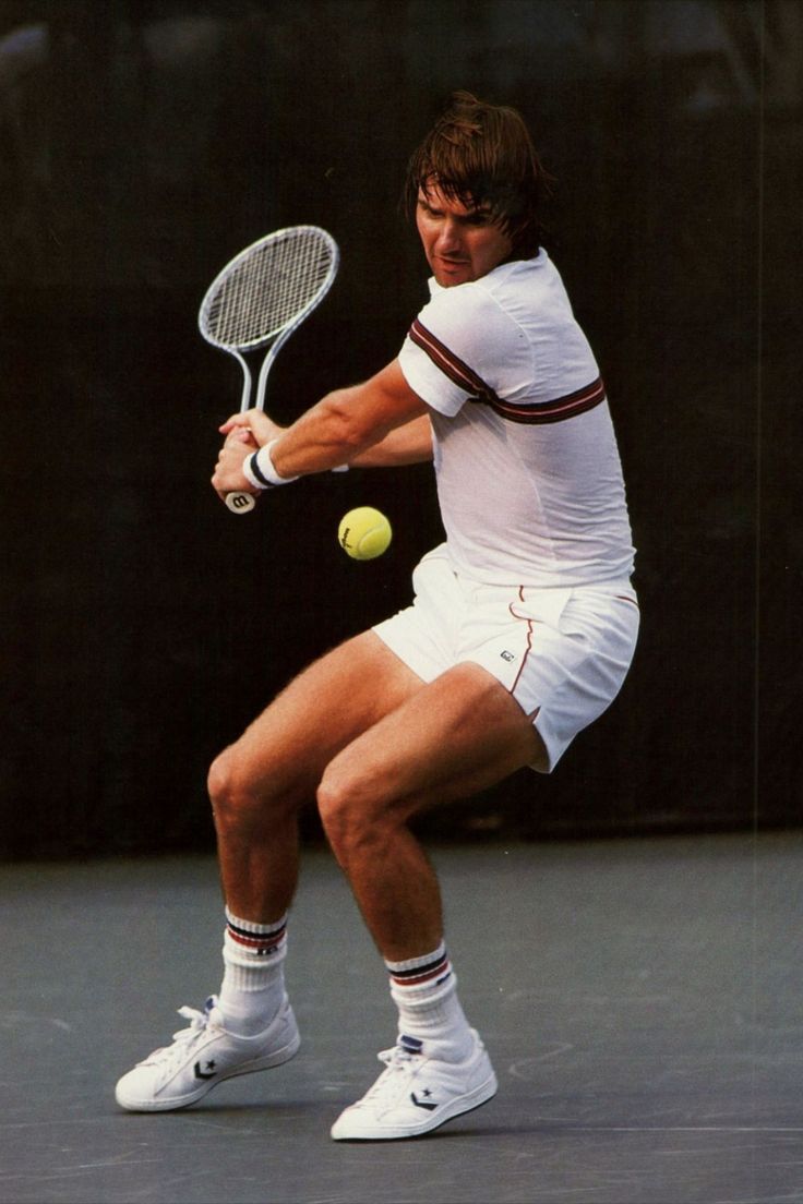 a male tennis player in action on the court