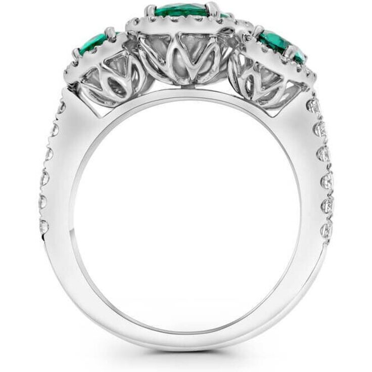 an emerald and diamond ring with three stone accents on the shoulders, set in white gold